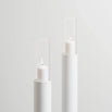 Set of 2 white floor candleholders with minimalist design, featuring candles in elegant glass holders.