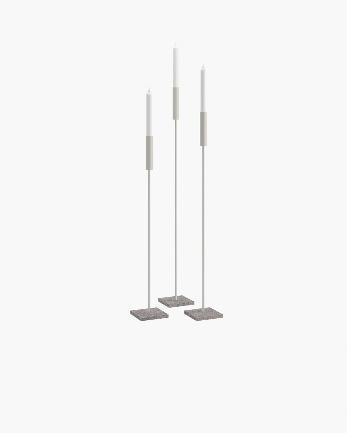Set of beige floor candleholders with turbine grey bases, creating a serene and minimalist atmosphere.