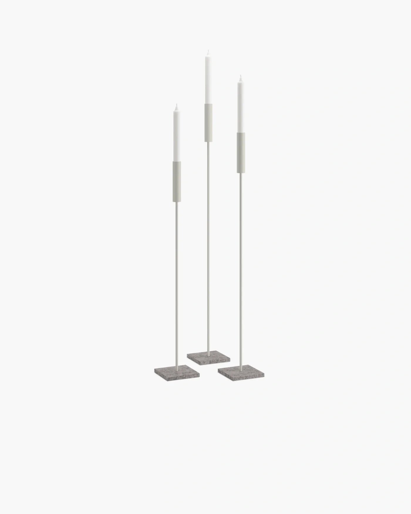 Set of beige floor candleholders with turbine grey bases, creating a serene and minimalist atmosphere.