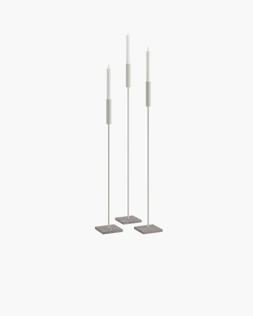 Set of beige floor candleholders with turbine grey bases, creating a serene and minimalist atmosphere.