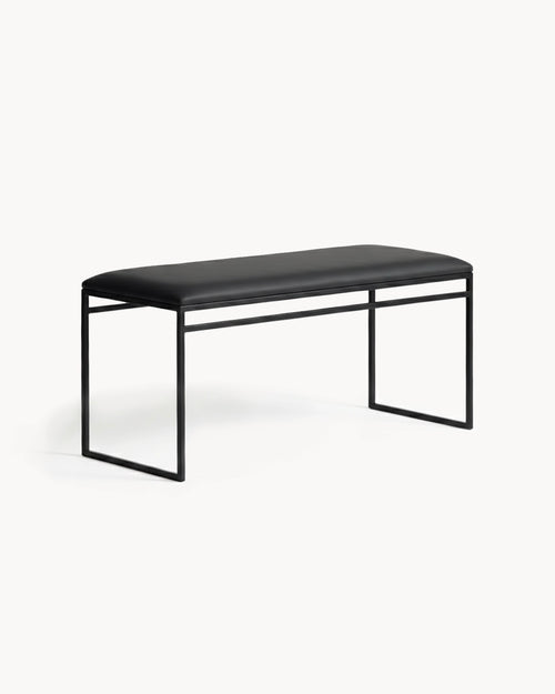 Bench Wilma with black frame and jade black leather cushion in minimalist design.