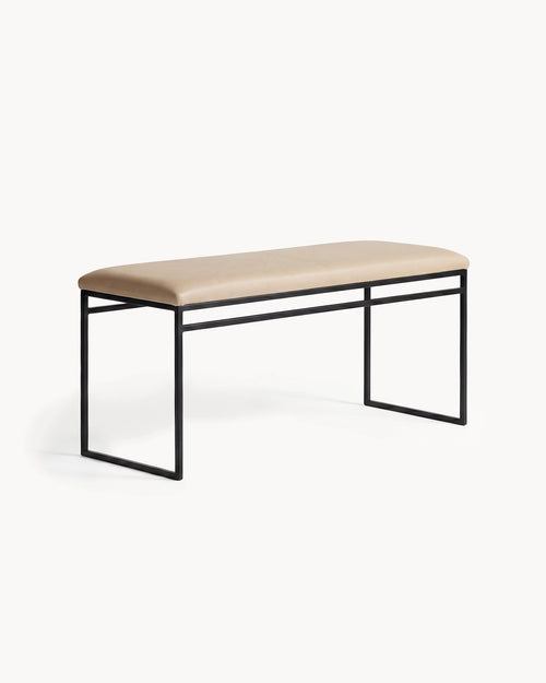 Bench Wilma with black frame and latte leather cushion in modern Scandinavian style.