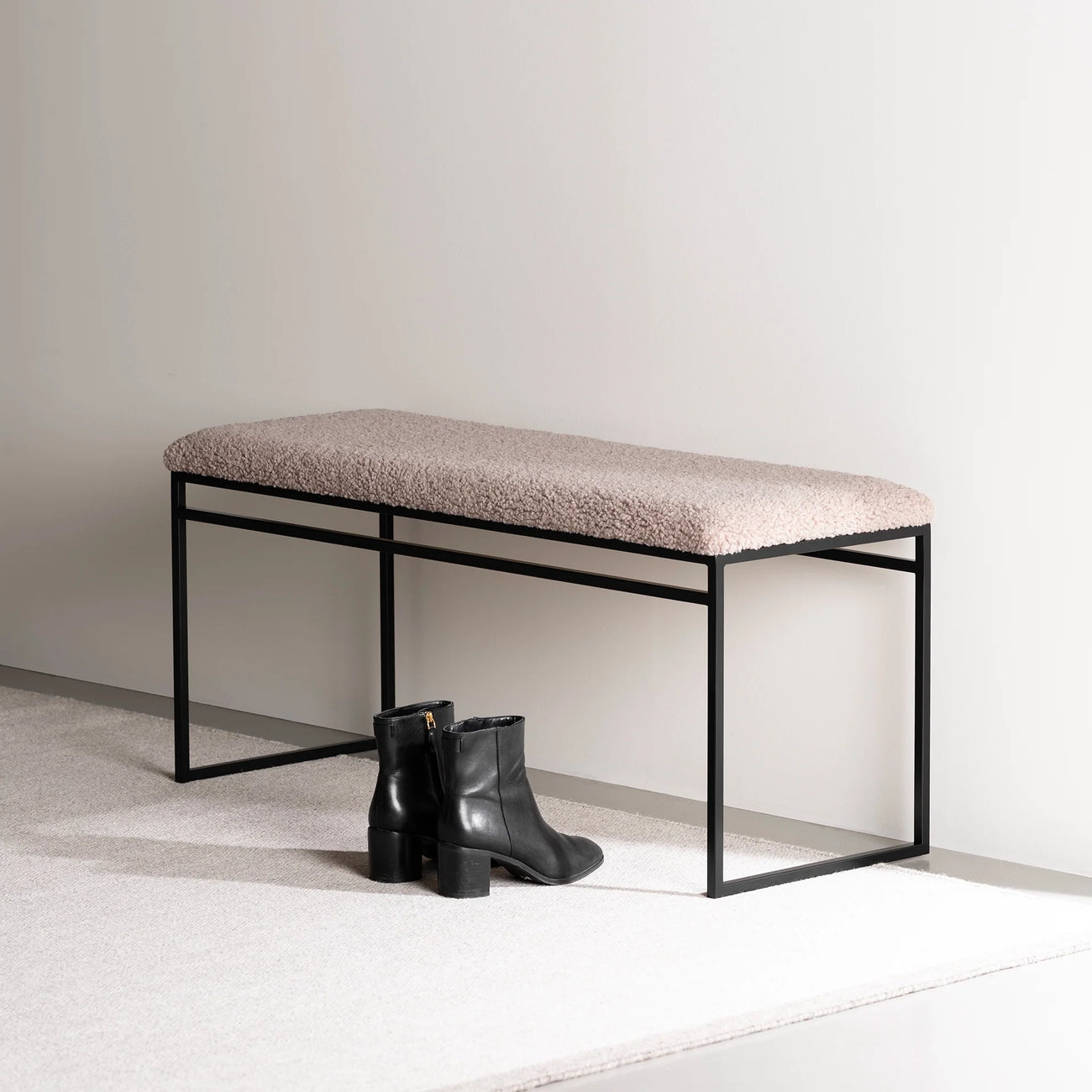 Wilma bench in black with greige bouclé, showcasing modern design and soft tones, perfect for serene interiors.