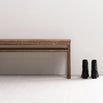 Wilma wood bench in dark oak finish next to stylish black boots, adding warmth to any space.