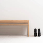 Wooden Bench Alva in natural oak frame against a minimalist wall, perfect for entryways or contemporary interiors.