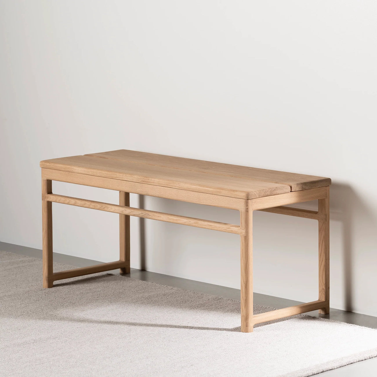 Wilma wood bench in solid oak featuring a minimalist Scandinavian design, ideal for hallways, bedrooms, or reading nooks.