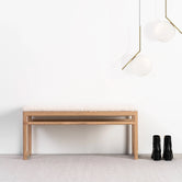 Wilma wood bench in natural oak with ivory bouclé upholstery, perfect for a calming decor in any room.